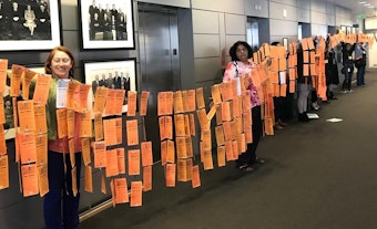caption: Seattle Silence Breakers unveiled postcards and banners Thursday, May 31 2018, that read 'Mayor Durkan, Stop All harassment & Discrimination now!'