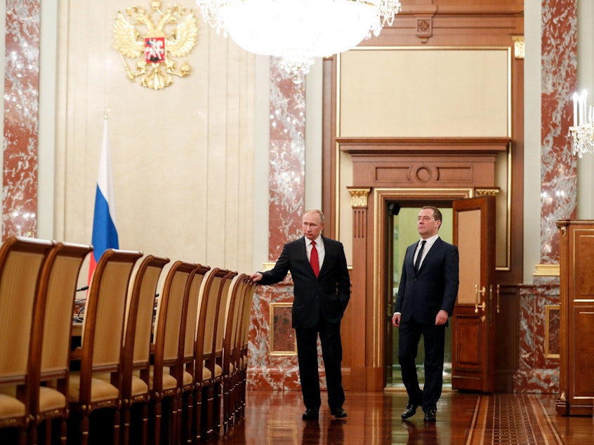 caption: Russian President Vladimir Putin and Prime Minister Dmitry Medvedev speak before a meeting with members of the government Wednesday in Moscow. The cabinet members resigned after Putin proposed a series of constitutional reforms, according to Russian news agencies.