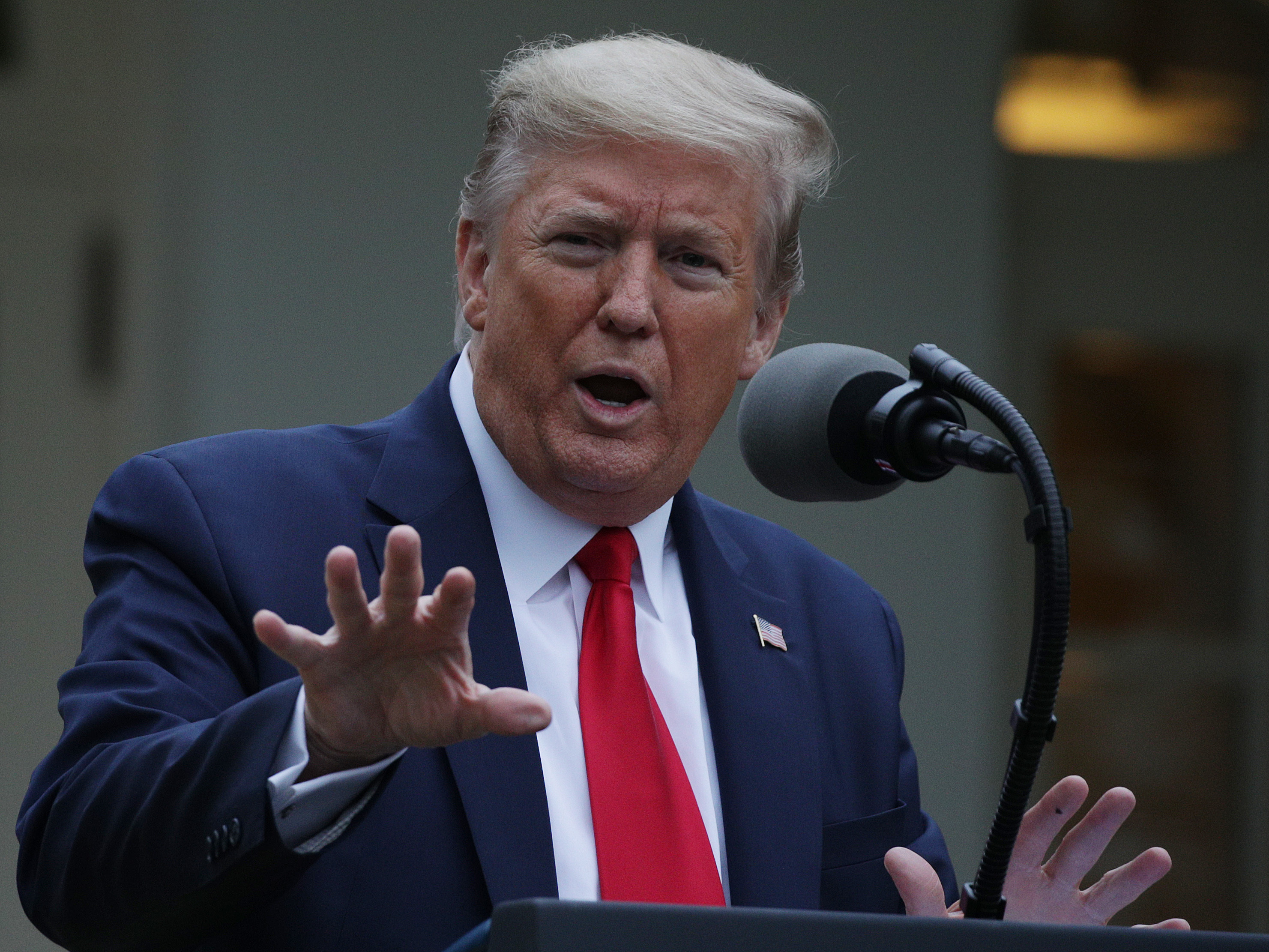 caption: President Trump addresses reporters in the White House Rose Garden during the daily coronavirus task force briefing on April 14.
