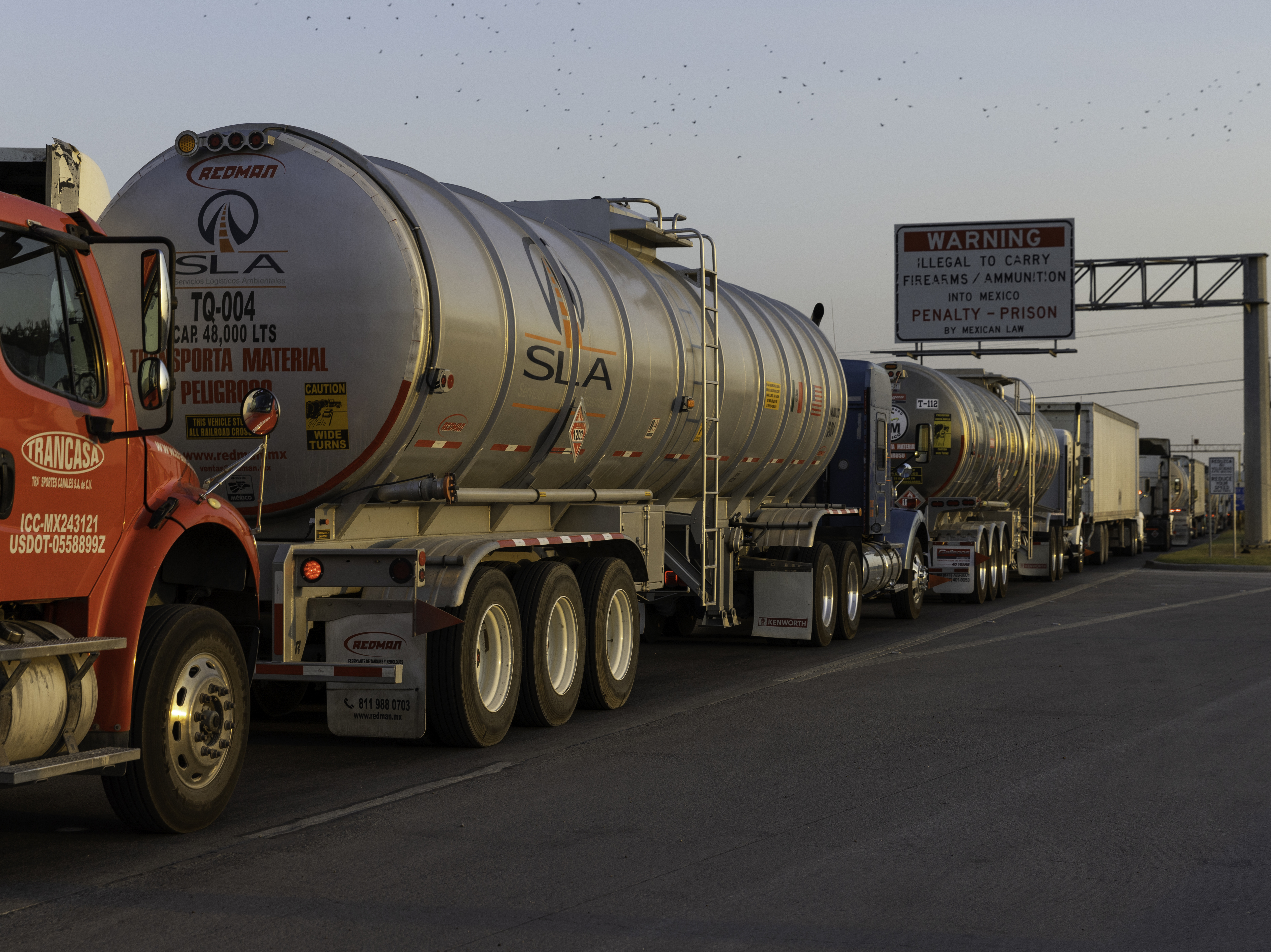 caption: Commercial trucks wait to cross the Pharr-Reynosa International Bridge in Pharr, Texas, last week, before Gov. Greg Abbott lifted his order requiring additional inspections of trucks arriving from Mexico.