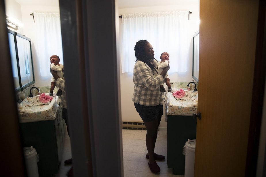 caption: LaTriece Arthur changes her newborn son Zoli Rae's diaper on Thursday, October 1, 2020, at their home on Vashon Island.