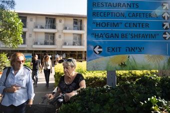 caption: Shefayim Hotel, just north of Tel Aviv, is hosting hundreds of survivors of Kibbutz Kfar Aza, a community that suffered some of the most catastrophic losses in the Hamas attacks two weeks ago.
