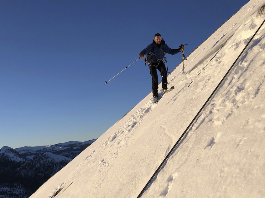 caption: In this photo provided by Jason Torlano, Zach Milligan is shown on his descent down Half Dome in Yosemite National Park, Calif., on Feb. 21. The two men climbed some 4,000 feet to the top of Yosemite's Half Dome in subfreezing temperatures and skied down the famously steep monolith to the valley floor.