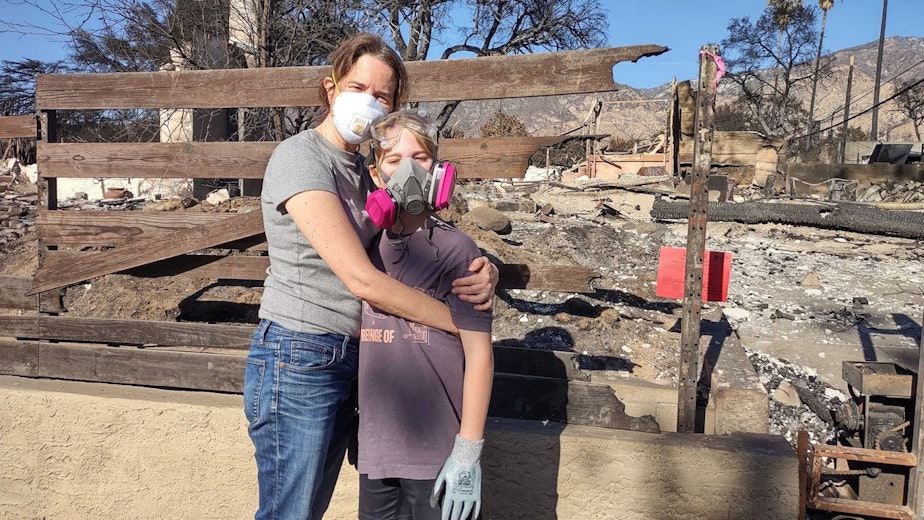 caption: Sarah Cole and 10-year-old Eli return to the ruins of their home in Altadena.