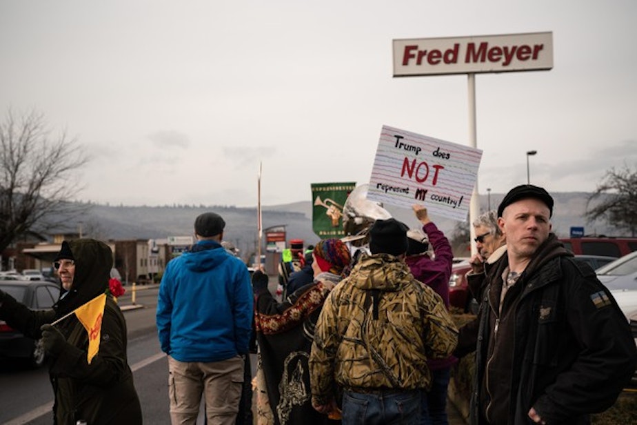 caption: <p>Ross Eliot, a leftist activist and proponent for armed self-defense, looks behind the Women&rsquo;s March for any possible threats on Jan. 19, 2019 in Hood River, Ore.</p>