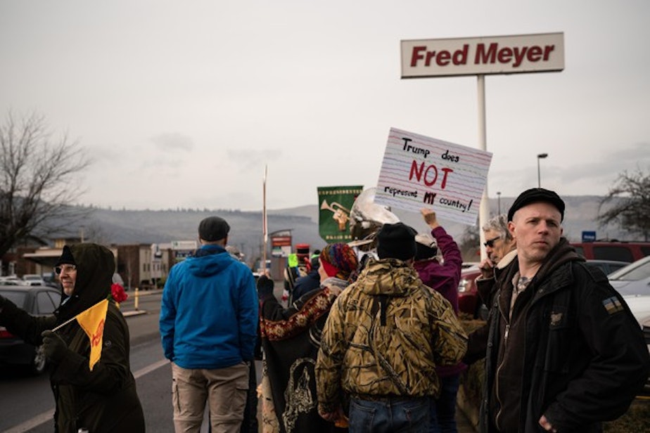 caption: <p>Ross Eliot, a leftist activist and proponent for armed self-defense, looks behind the Women’s March for any possible threats on Jan. 19, 2019 in Hood River, Ore.</p>