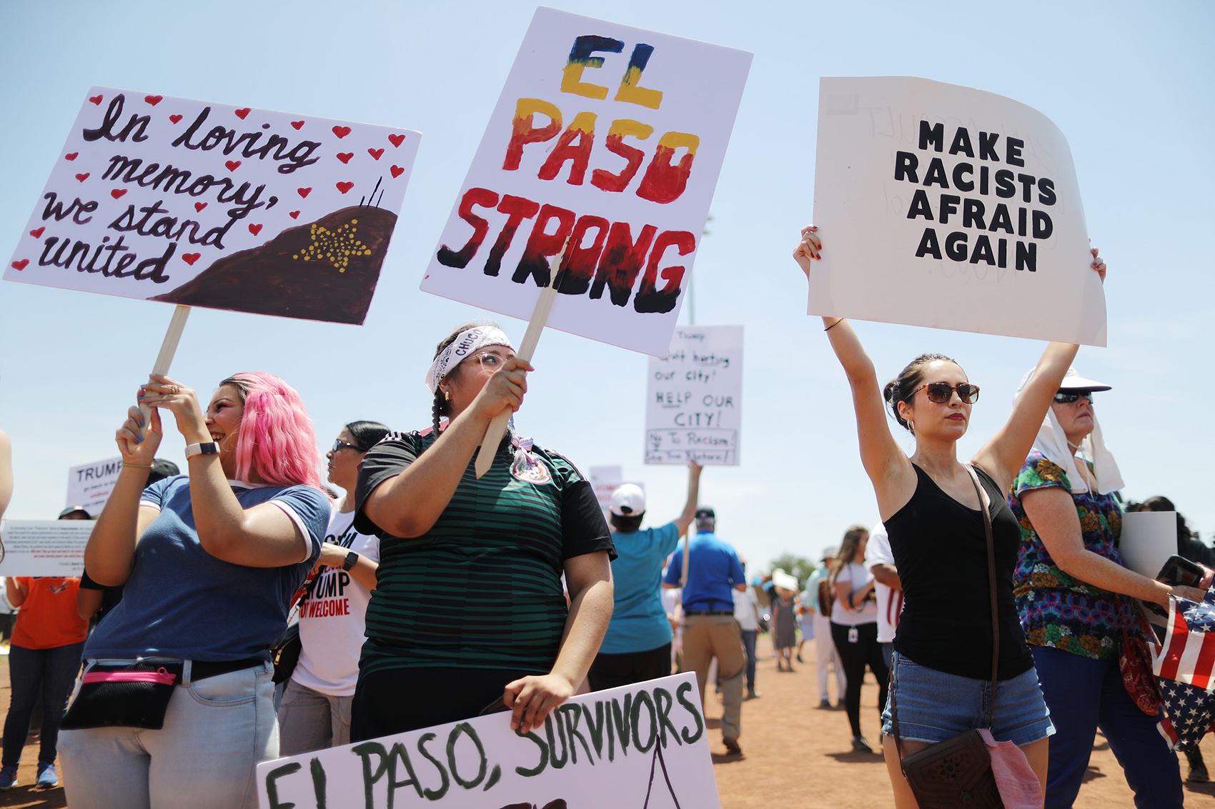 caption: Demonstrators stand at a protest against President Trump's visit following a mass shooting, which left at least 22 people dead, on August 7, 2019 in El Paso, Texas. Protestors also called for gun control and denounced white supremacy. (Mario Tama/Getty Images)