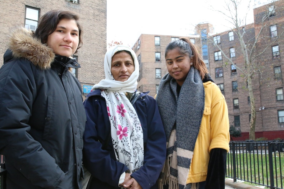 caption: Queensbridge Houses tenant Nayrin Muhith (center), with affordable housing advocates Lena Afridi (left) and Sabrina Jalal (right).