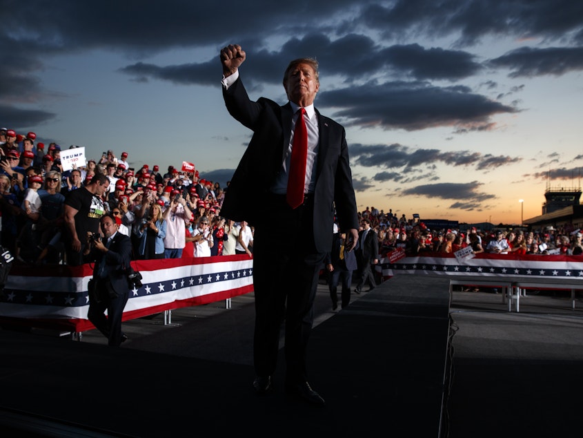 caption: President Trump pumps his fist after speaking at a campaign rally in Montoursville, Pa. He's calling a rally in Orlando, Fla., Monday a campaign  kickoff, as he is threatening to deport "millions."