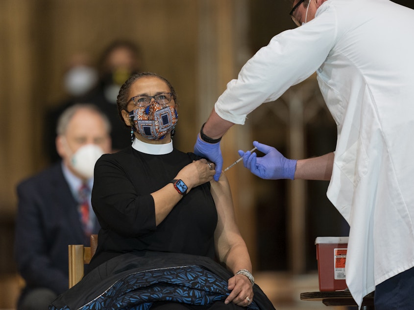 caption: A pastor is administered with the Johnson & Johnson COVID-19 vaccine in May, during a gathering of a group of interfaith clergy members, community leaders and officials at the Washington National Cathedral, to encourage faith communities to get the COVID vaccine.