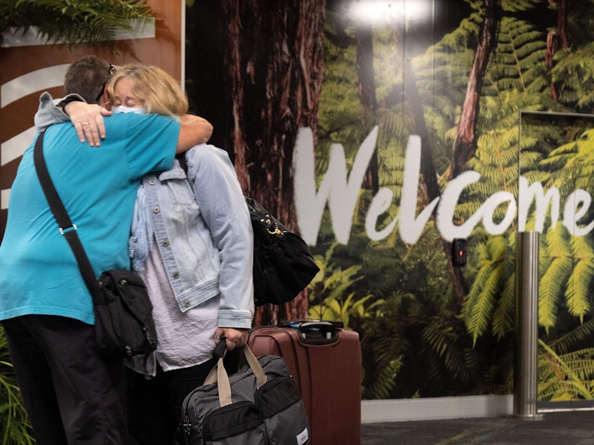 caption: Families are reunited as travelers arrive on the first flight from Sydney in Wellington on Monday after Australia and New Zealand opened a trans-Tasman quarantine-free travel bubble.