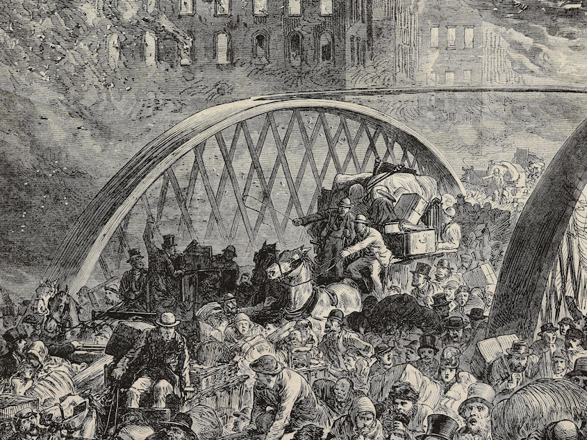 caption: An engraving from the Illustrated London News in 1871 of the Randolph Street Bridge during the Great Chicago Fire.