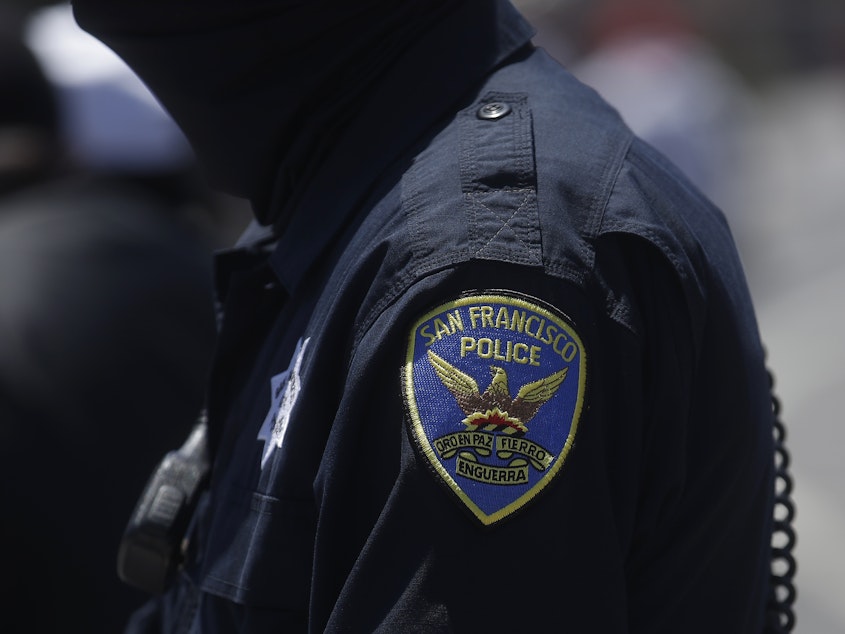 caption: A San Francisco Police Department patch is shown on an officer's uniform. A new Pew Research Center survey shows changing opinions about law enforcement.