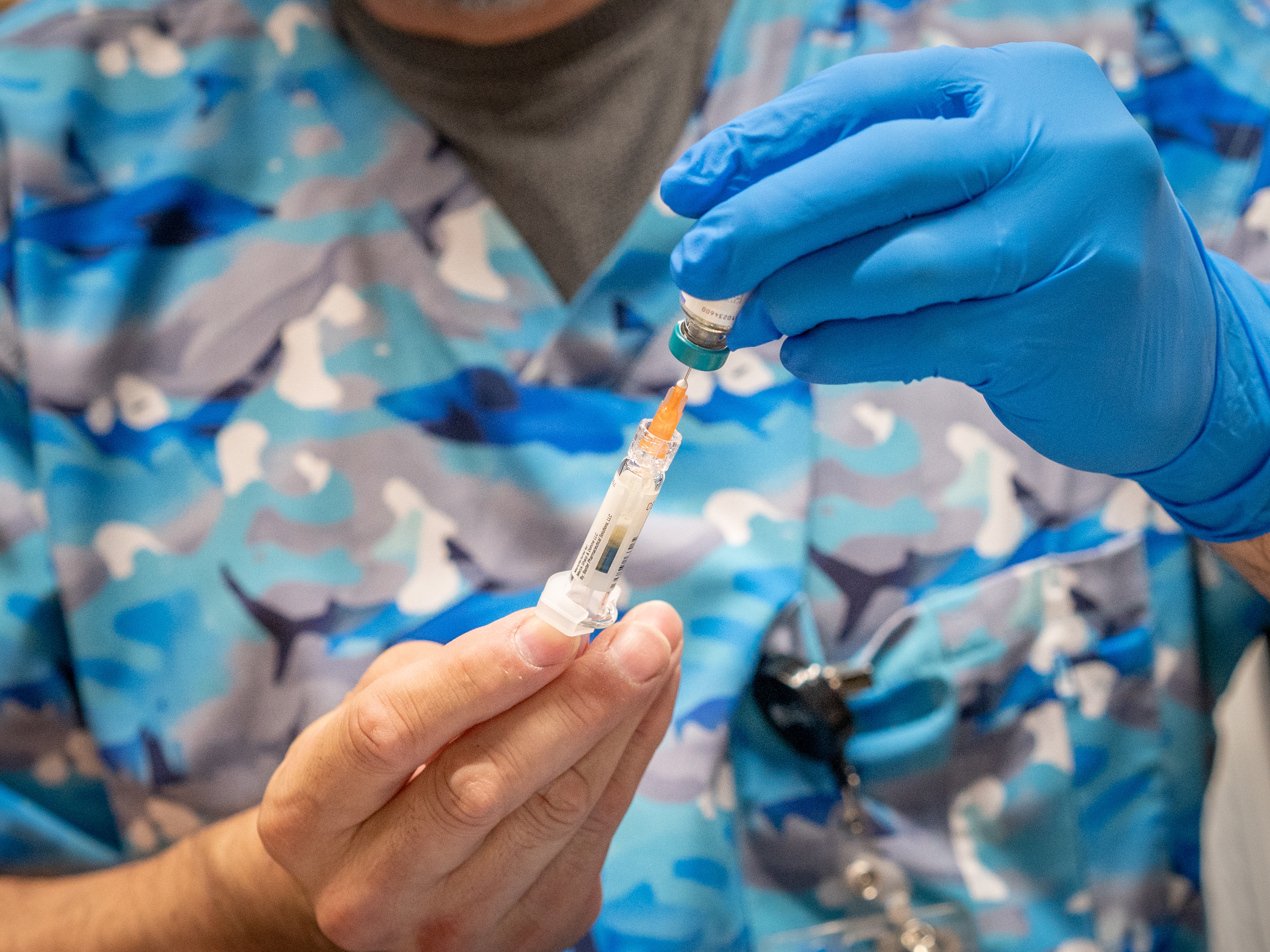 caption: Raynard Covarrubio fills a syringe with the MMR vaccine, at a vaccine clinic put on by Lubbock Public Health Department on March 1 in Lubbock, Texas. West Texas saw a measles outbreak this year.
