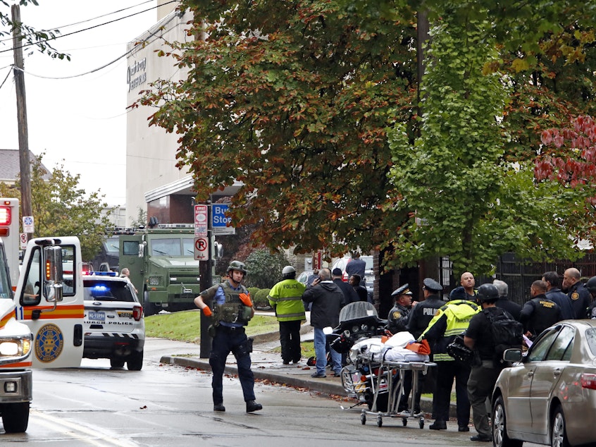 caption: First responders surround the Tree of Life Synagogue in Pittsburgh, where a shooter opened fire Saturday morning.