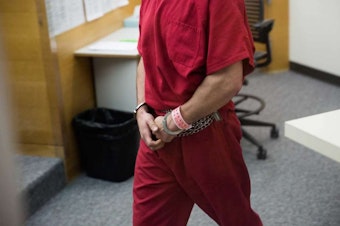 caption: John Robert Charlton appears in King County Jail Court in Seattle on Tuesday after being arrested in the slaying of Ingrid Lyne of Renton.