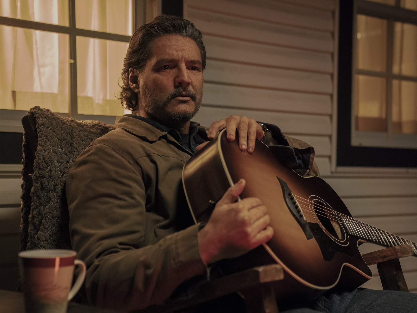 caption: Pedro Pascal plays Joel, a man who's daughter has died, in the HBO series <em>The Last of Us.</em>