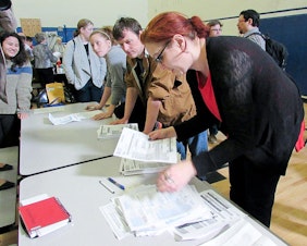 caption: Precinct volunteers count caucus votes at Martin Luther King Jr. Elementary School in Seattle on Saturday, March 26. Democrats turned out across the state to support Bernie Sanders or Hillary Clinton.