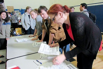 caption: Precinct volunteers count caucus votes at Martin Luther King Jr. Elementary School in Seattle on Saturday, March 26. Democrats turned out across the state to support Bernie Sanders or Hillary Clinton.
