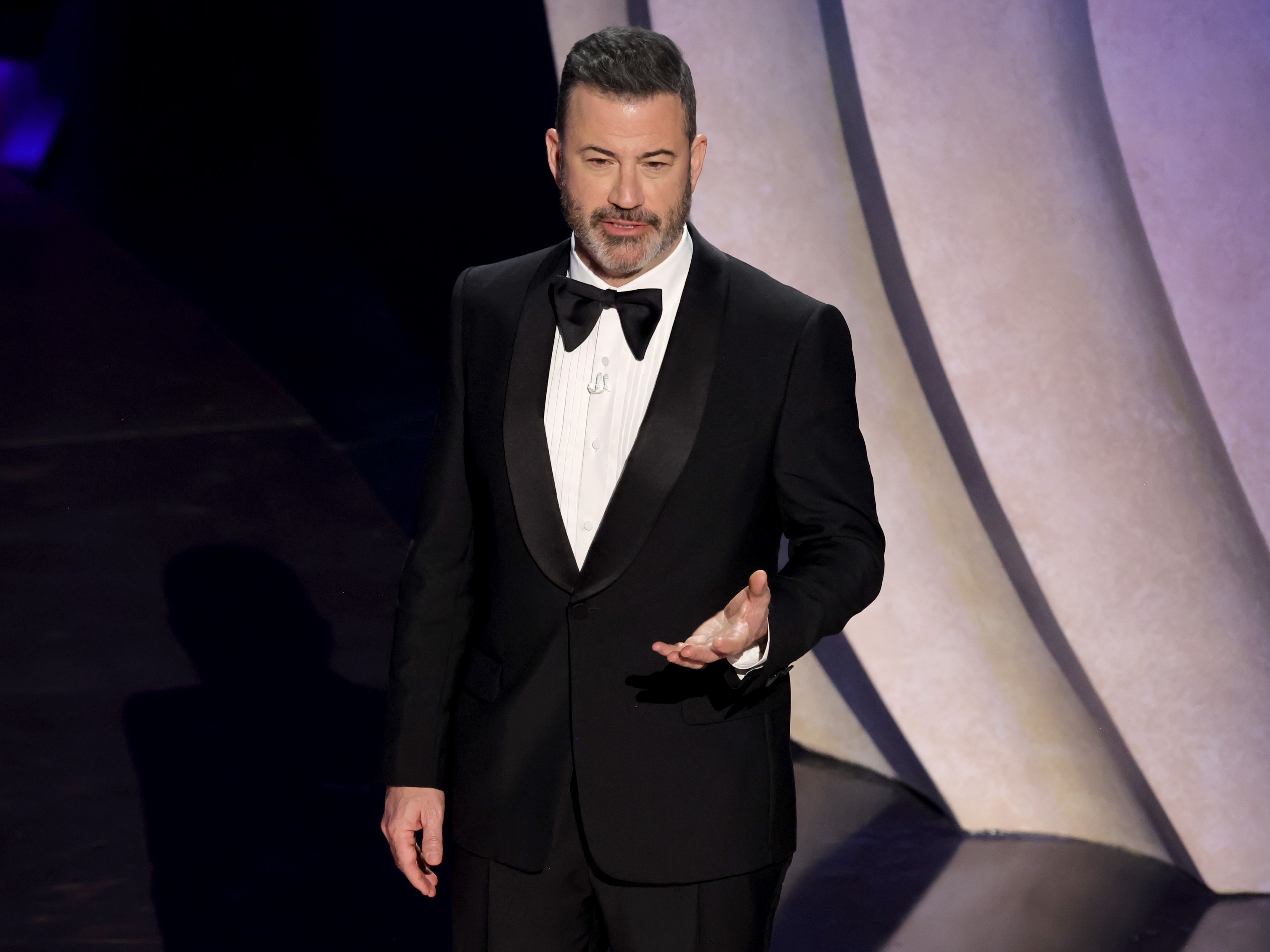 caption: Jimmy Kimmel speaks onstage while hosting the 96th Annual Academy Awards in March 2024. Labor unions, free speech groups and fellow entertainers are rallying around him after ABC suspended his late-night show on Wednesday.