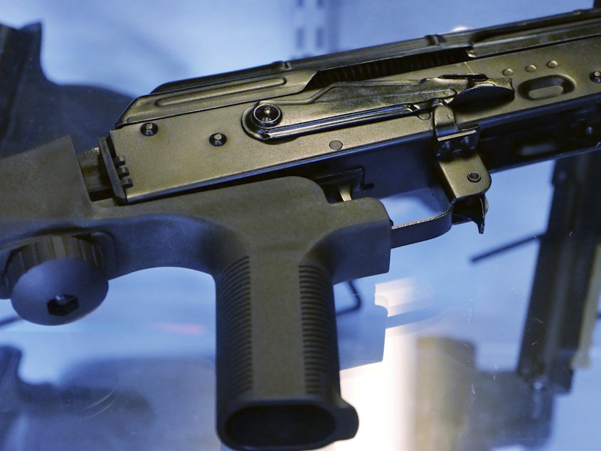 caption: In this Oct. 4, 2017 file photo, a device called a "bump stock" is attached to a semi-automatic rifle at the Gun Vault store and shooting range in South Jordan, Utah. The U.S. Supreme Court overturned a Trump-era federal ban on bump stocks. Following the 2019 ban, tens of thousands of the devices were destroyed by owners or handed over to authorities.