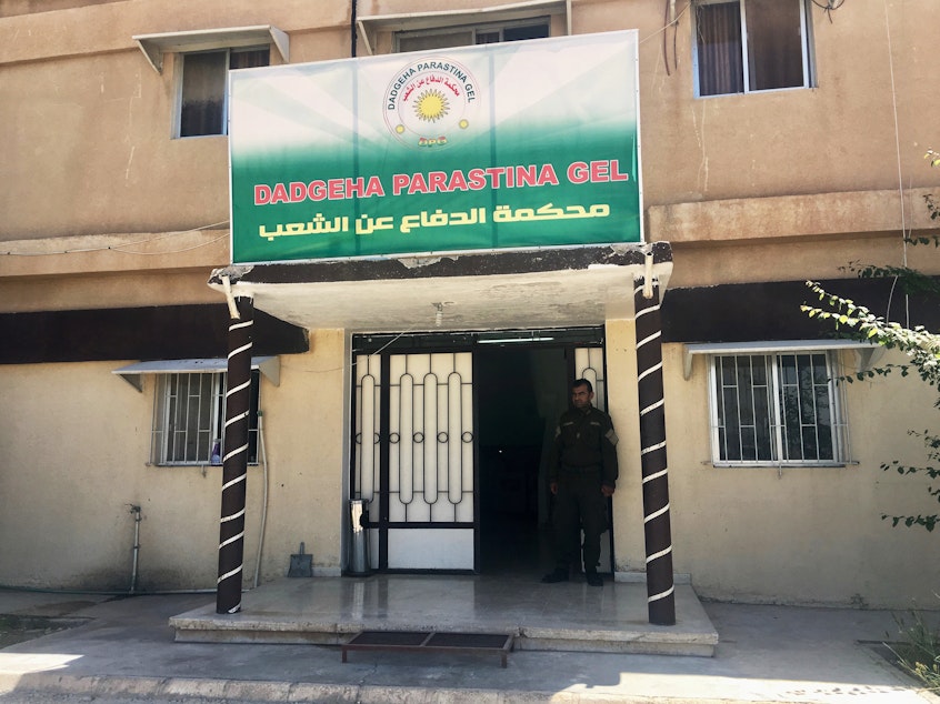 caption: The People's Defense Court in the Rojava district of northeast Syria. Judges here have been holding trials of thousands of ISIS fighters. The Kurdish-led region broke from Syrian government control in 2012 and has developed its own justice system that it says adheres to Western standards of human rights.