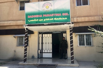 caption: The People's Defense Court in the Rojava district of northeast Syria. Judges here have been holding trials of thousands of ISIS fighters. The Kurdish-led region broke from Syrian government control in 2012 and has developed its own justice system that it says adheres to Western standards of human rights.