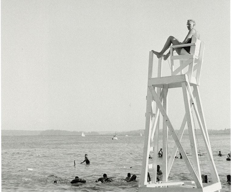 caption: Sonny Norris was Seattle's first Black lifeguard, pictured here at Madrona Beach in 1955. Madrona Beach was considered Seattle's Black beach for swimming and picnics, per MOHAI's book on Al Smith, 'Seattle on the Spot.' 
