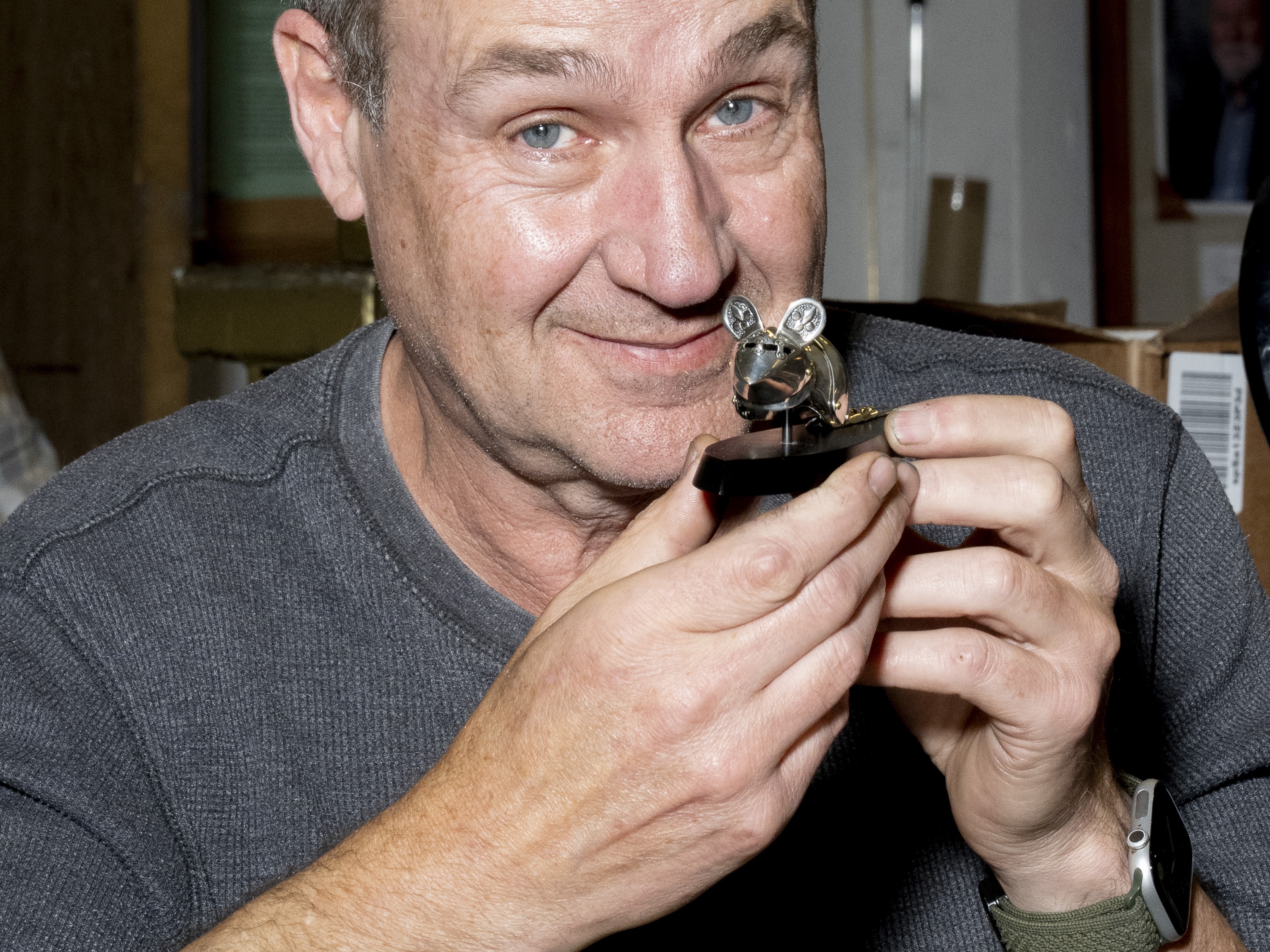 caption: Jeff de Boer poses with one of his mouse armor pieces at a workshop at Pratt Fine Arts Center in Seattle, Wash., on Oct. 9.