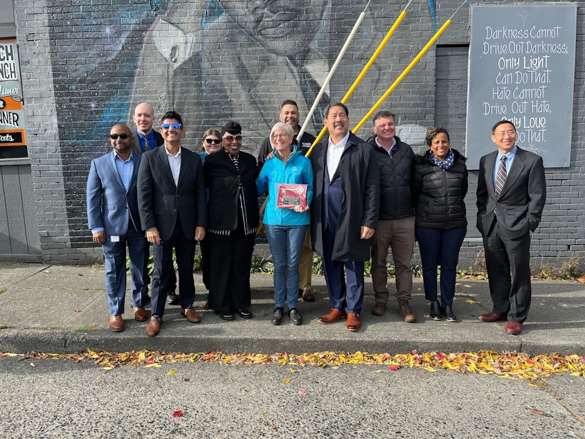 caption: Mayor Bruce Harrell stands with community leaders in front of an MLK mural at Fats Chicken and Waffles located at Martin Luther King Jr Way and Cherry Street. Harrell announce his proposal to address graffiti in Seattle. 