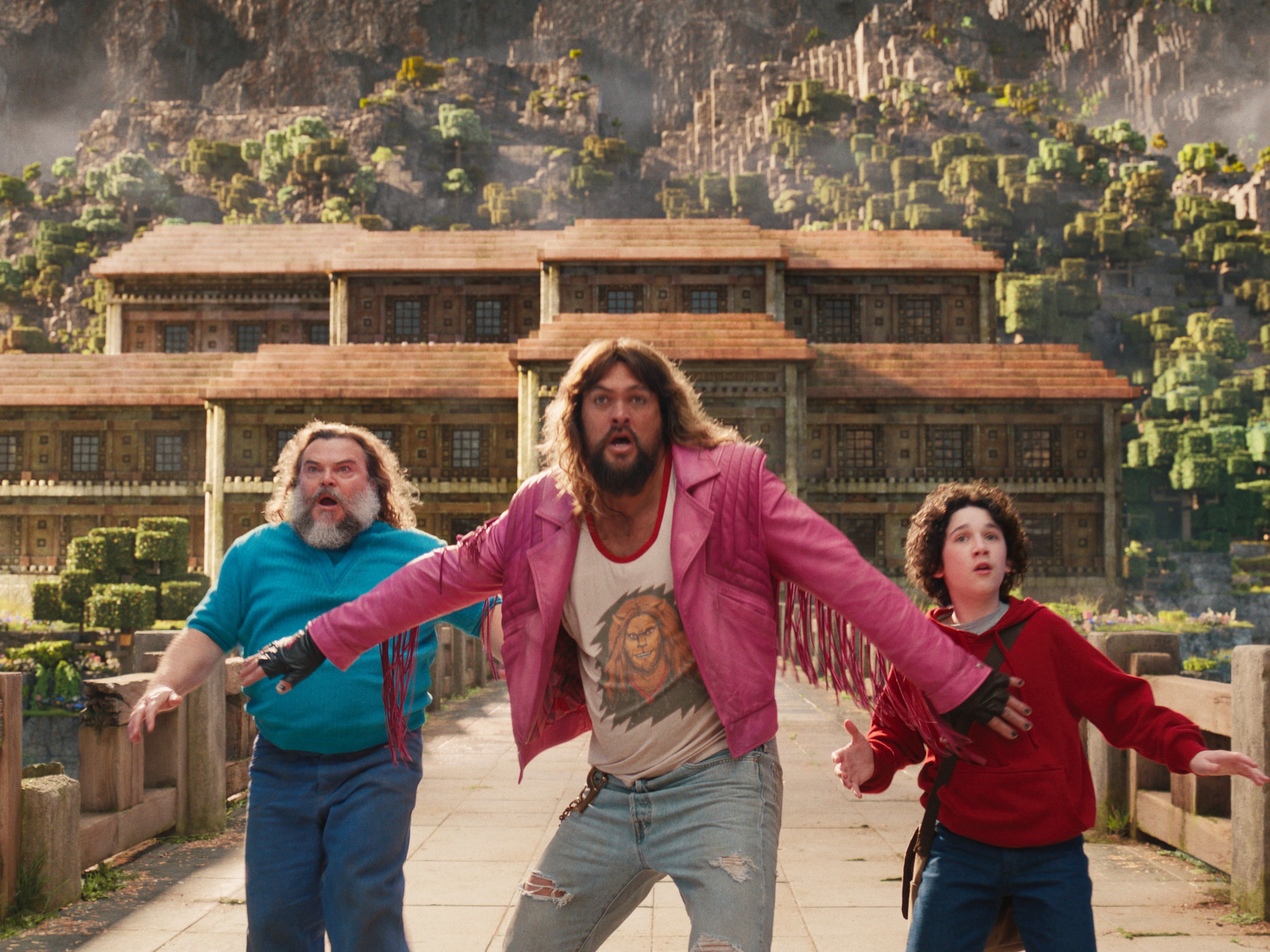 caption: from L to R: Jack Black, Jason Momoa and Sebastian Eugene Hansen star in <em>A Minecraft Movie</em>