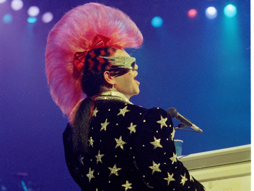 caption: Elton John and his mohawk perform at Universal Amphitheater in Universal City, Calif., in 1986.