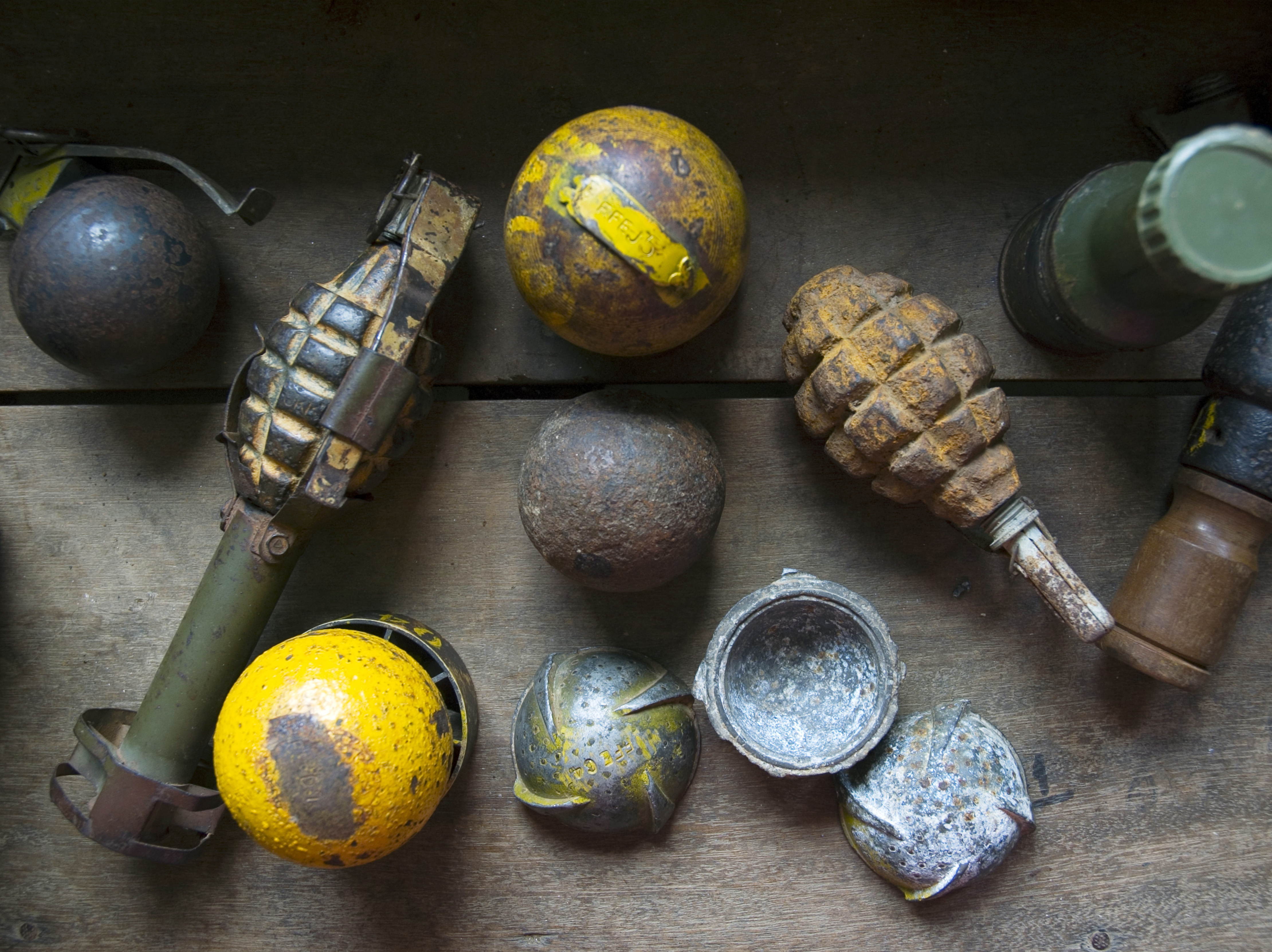 caption: View of a collection of defused cluster bombs and grenades used by an international bomb disposal group for training in Savannakhet, Laos, on May 2, 2006.