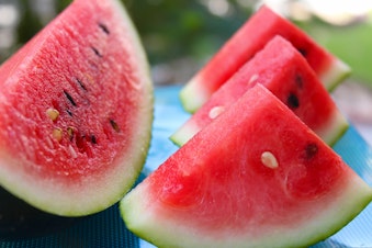 caption: University of Washington dietician Kelly Morrow recommends cutting up pieces of watermelon and freezing them for a satisfying heat wave snack.