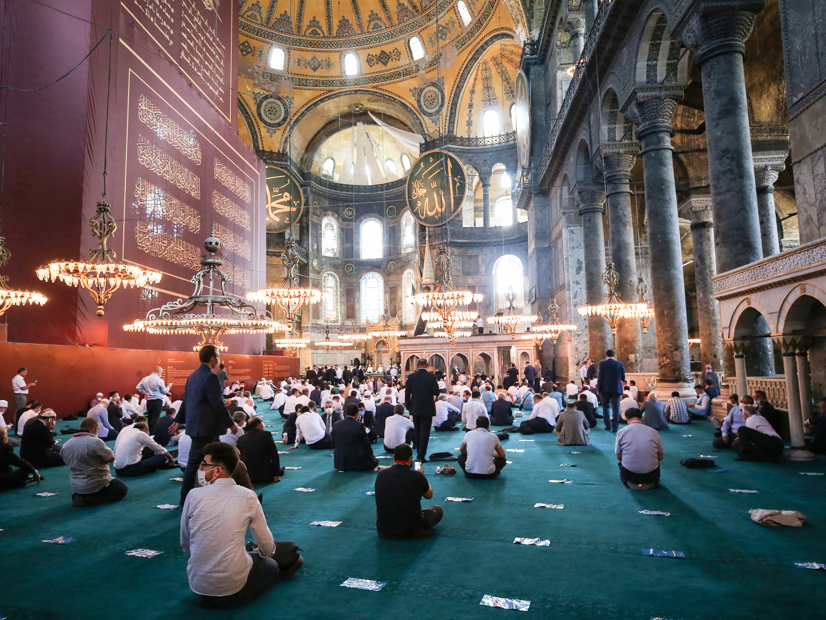 caption: People gather to perform Friday prayers at Istanbul's Hagia Sophia for the first time in 86 years.