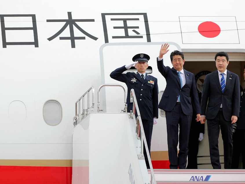 caption: Japan's Prime Minister Shinzo Abe waves to well-wishers on his departure from Tokyo's Haneda Airport on Wednesday for a two-day visit to Iran.