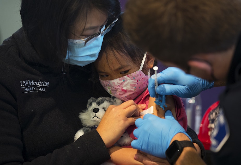caption: Vivienne Wong, 5, is comforted by her mother, Crystal Wong, while receiving the Pfizer Covid-19 vaccine on Wednesday, November 3, 2021, at the UW Medicine North King County Vaccination Clinic in Shoreline. 