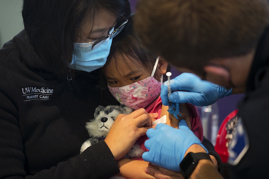 caption: Vivienne Wong, 5, is comforted by her mother, Crystal Wong, while receiving the Pfizer Covid-19 vaccine on Wednesday, November 3, 2021, at the UW Medicine North King County Vaccination Clinic in Shoreline. 