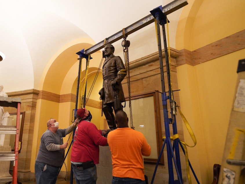 caption: A statue of Robert E. Lee was removed from the U.S. Capitol early Monday.