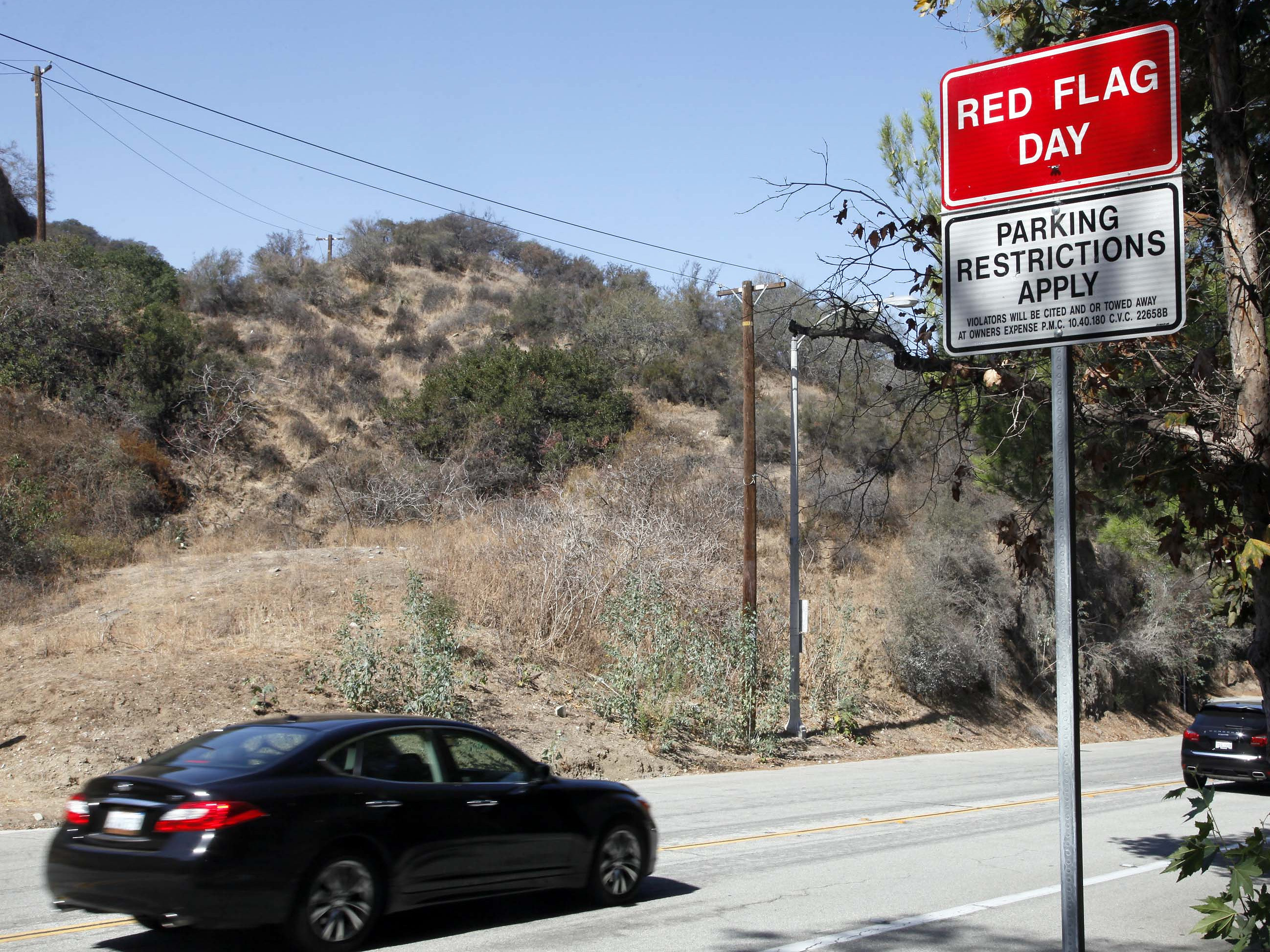 caption: A red flag fire warning sign as seen in October 2013 in Pasadena, Calif.