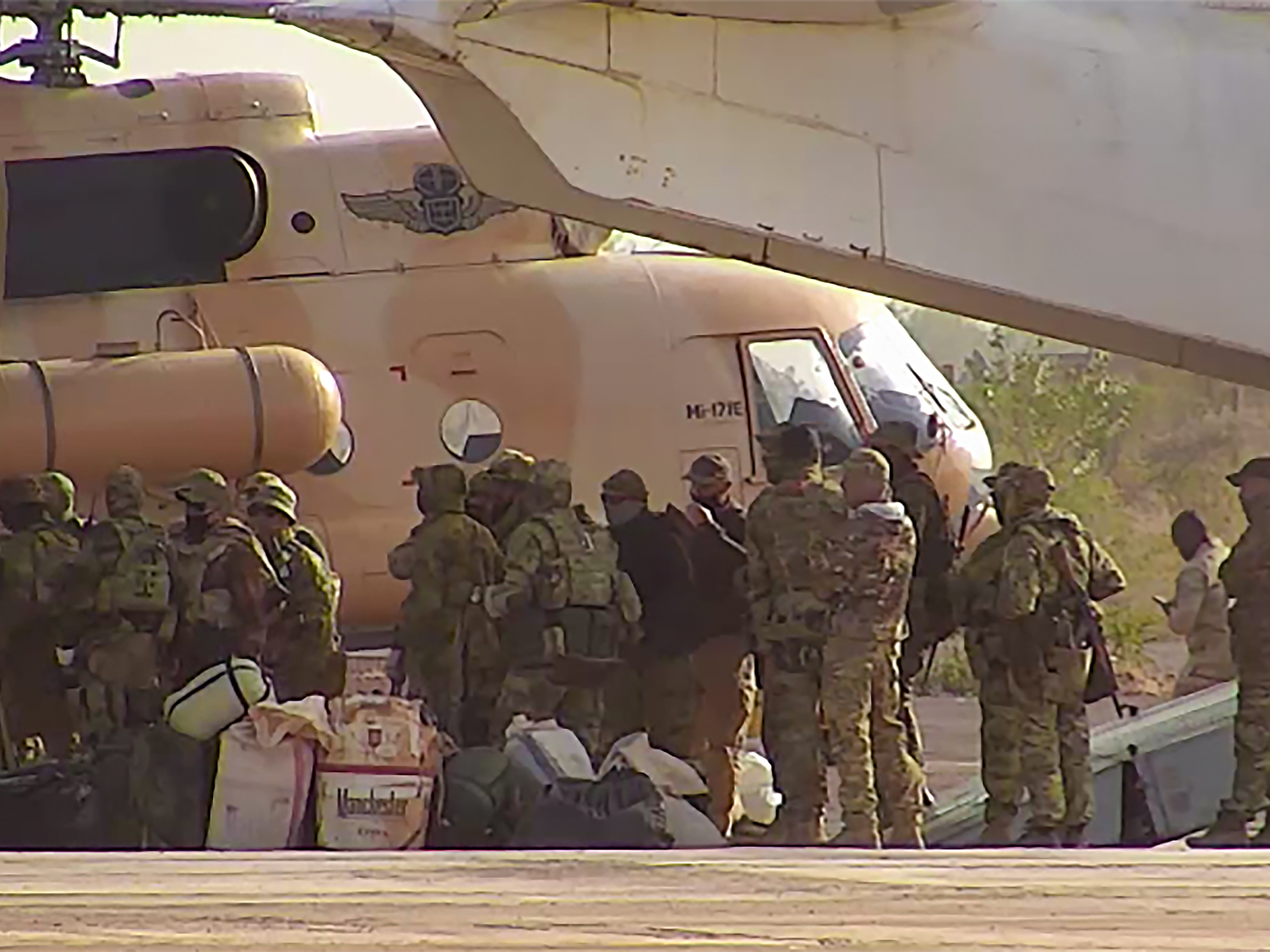 caption: This undated photograph released in April 2022 by France's military shows Russian mercenaries boarding a helicopter in northern Mali.