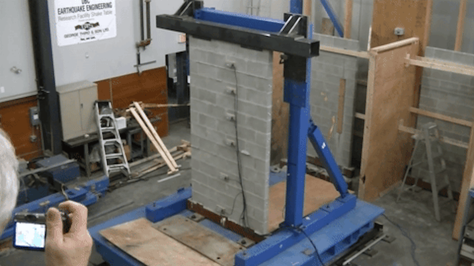 caption: An unreinforced masonry wall fails a shake test at the University of British Columbia