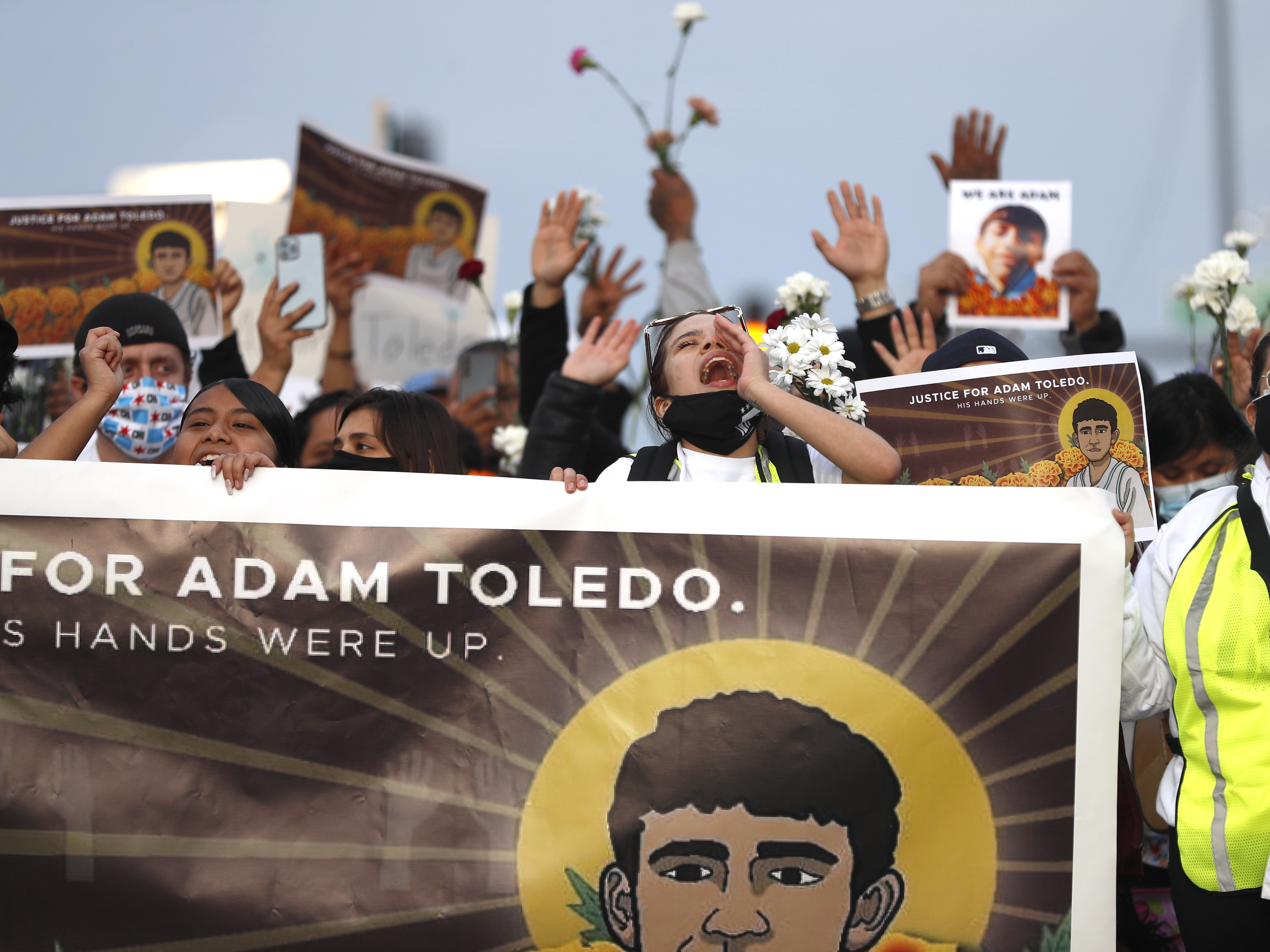caption: Demonstrators attend a peace walk honoring the life 13-year-old Adam Toledo on April 18, 2021, in Chicago's Little Village neighborhood.