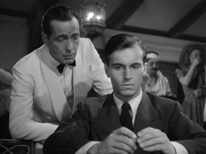 caption: A screenshot from <em>Casablanca</em> showing Humphrey Bogart and Helmut Dantine.