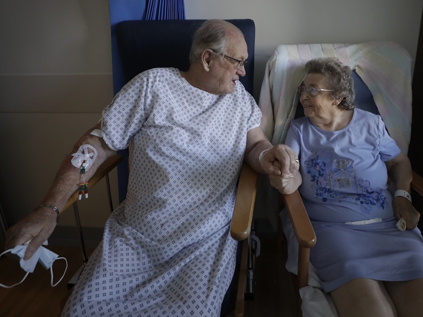 caption: English coronavirus patients George Gilbert, 85, and his wife, Domneva Gilbert, 84, were part of a clinical trial that included Eli Lilly & Co.'s baricitinib.