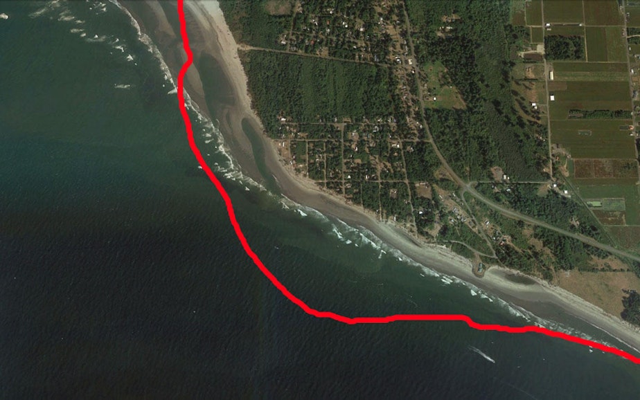 caption: Satellite view of Washaway Beach in 2011. The red line marks the shoreline in 1990.