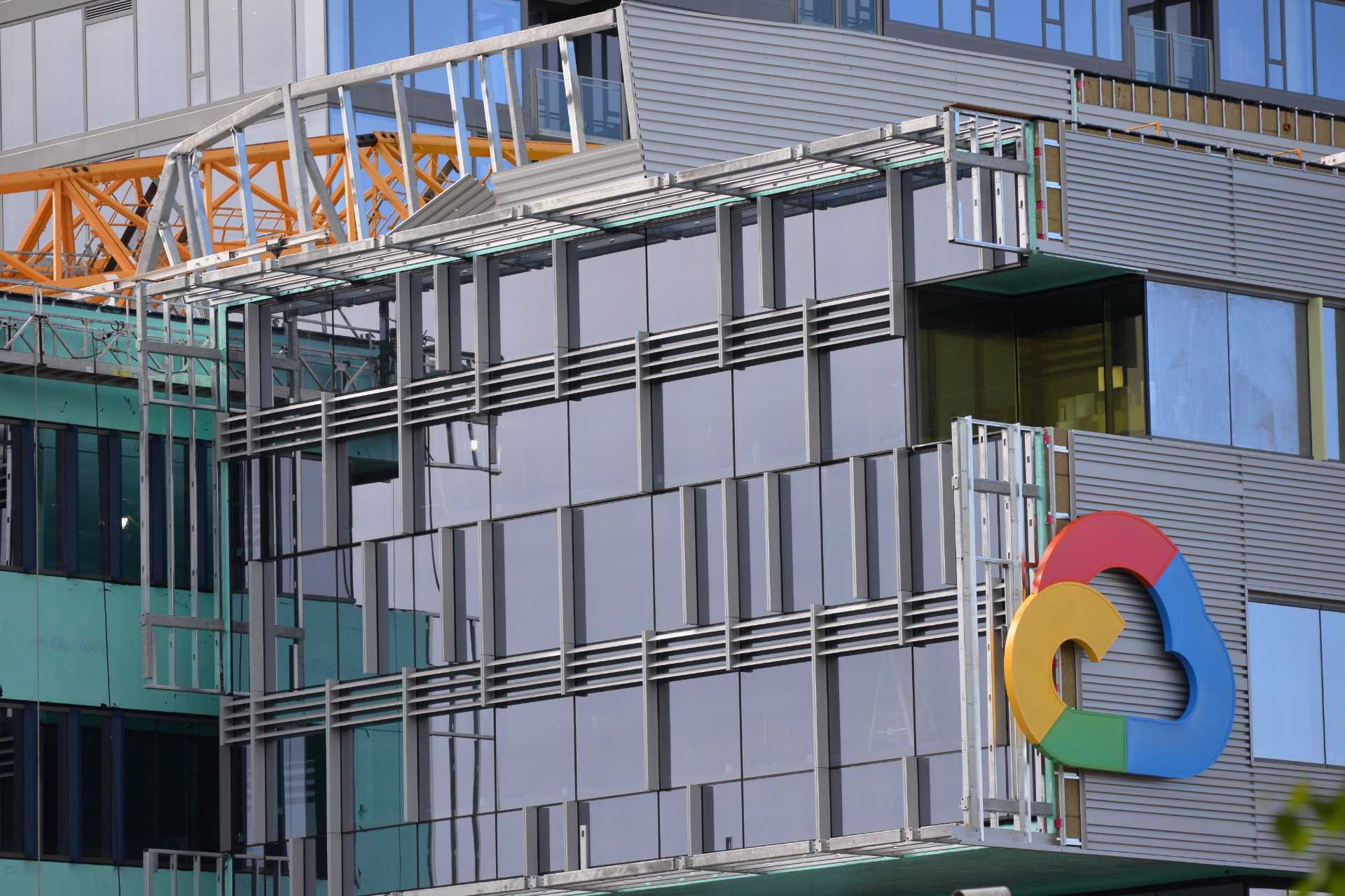 caption: A crane collapsed on a building with a Google logo on Saturday, April 27, 2019.