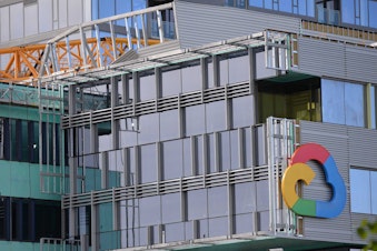 caption: A crane collapsed on a building with a Google logo on Saturday, April 27, 2019.