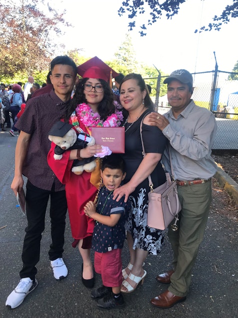 caption: Eriberto (left) with his family at his sister's graduation.