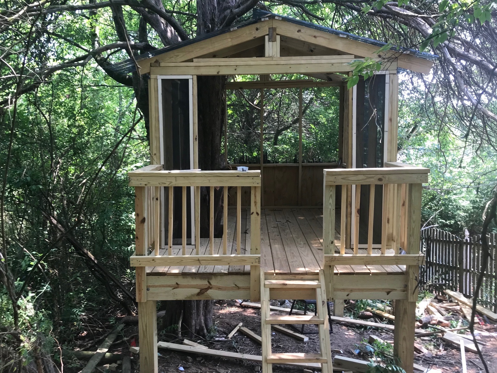 caption: With the help of his children, Knoxville, Tenn., resident Matt Harris put the finishing touches on his dream treehouse on Father's Day.